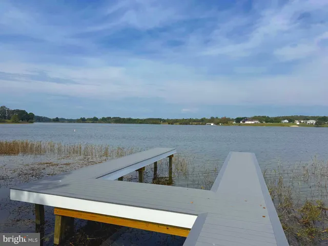 a view of a lake with houses in the back