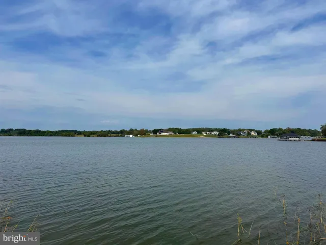 en empty room with a fireplace and wooden floor