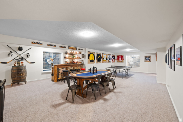 6208 West Bull River Road Highland, UT 84003 - Photo 46 of 90 Spacious entertainment area featuring a custom wood bar, recessed lighting, and light-colored carpet flooring