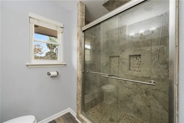 a bathroom with a glass shower door