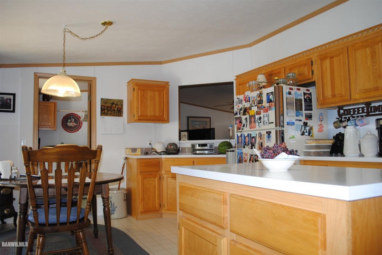 8676 West Diggin Hill Road Hanover, IL 61041 - Photo 3 of 25 a view of a dining room with furniture and chandelier