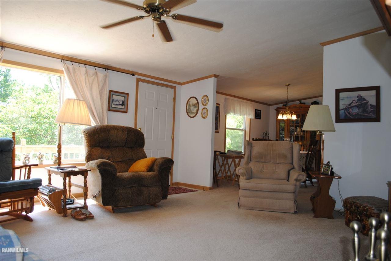 8676 West Diggin Hill Road Hanover, IL 61041 - Photo 9 of 25 a living room with furniture and a large window