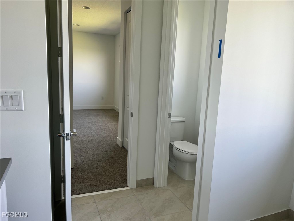 5101 Isidora Lane Ave Maria, FL 34142 - Photo 18 of 33 a bathroom with a granite countertop toilet