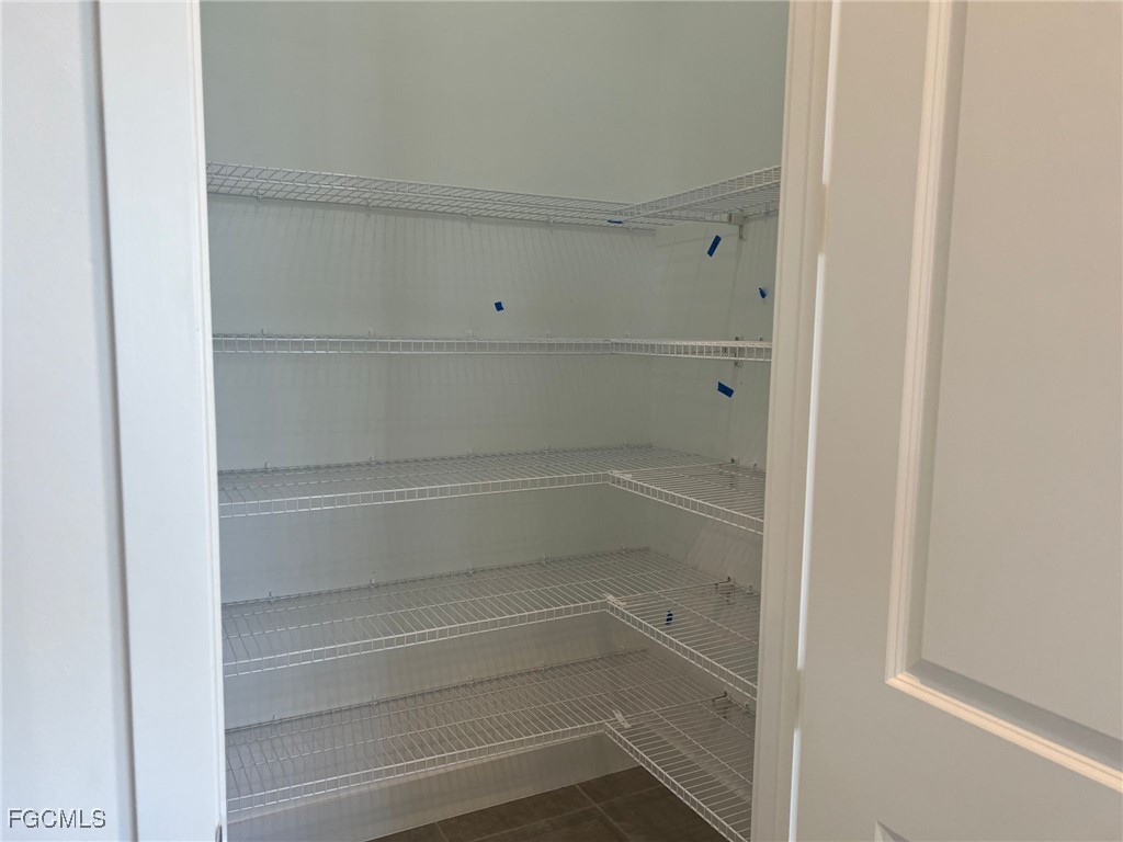 5101 Isidora Lane Ave Maria, FL 34142 - Photo 24 of 33 a view of walk in closet with empty racks