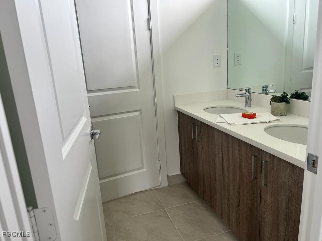 5101 Isidora Lane Ave Maria, FL 34142 - Photo 27 of 33 a bathroom with a sink and mirror