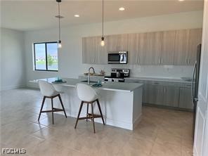 5101 Isidora Lane Ave Maria, FL 34142 - Photo 9 of 33 a kitchen with a sink cabinets and window