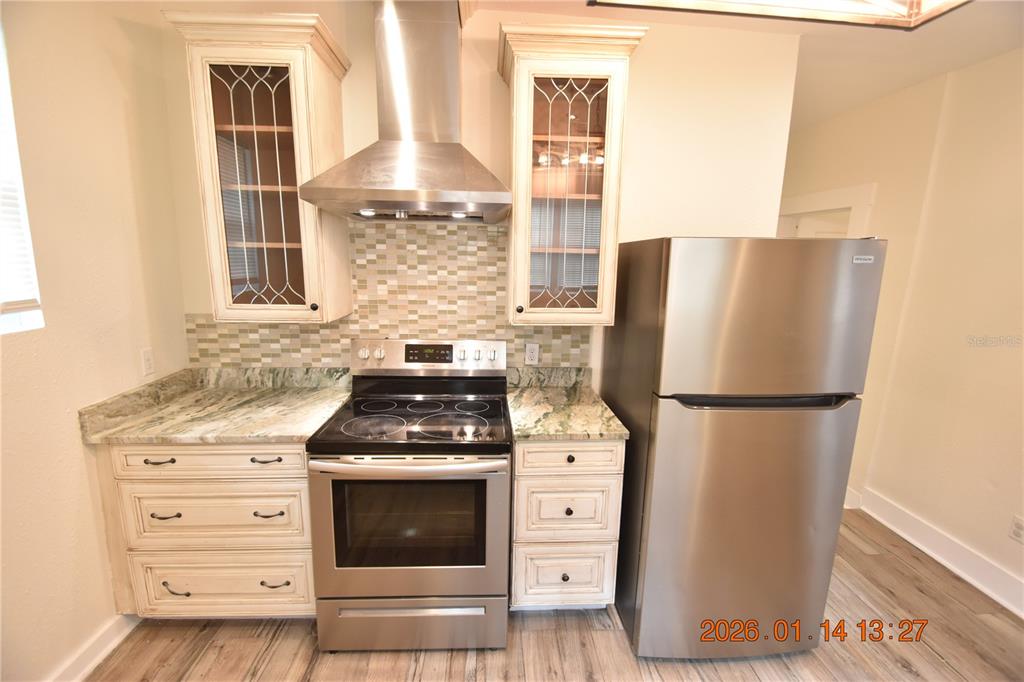 907 East Patterson Street Tampa, FL 33604 - Photo 12 of 35 a kitchen with granite countertop a refrigerator and a stove
