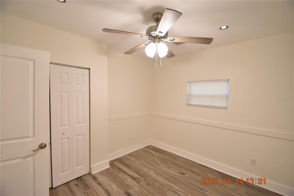 907 East Patterson Street Tampa, FL 33604 - Photo 16 of 35 an empty room with wooden floor closet and fan