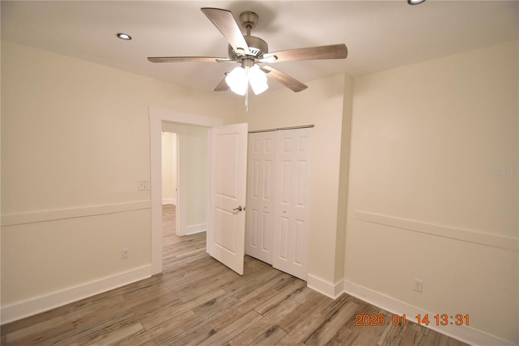 907 East Patterson Street Tampa, FL 33604 - Photo 17 of 35 an empty room with wooden floor fan and windows