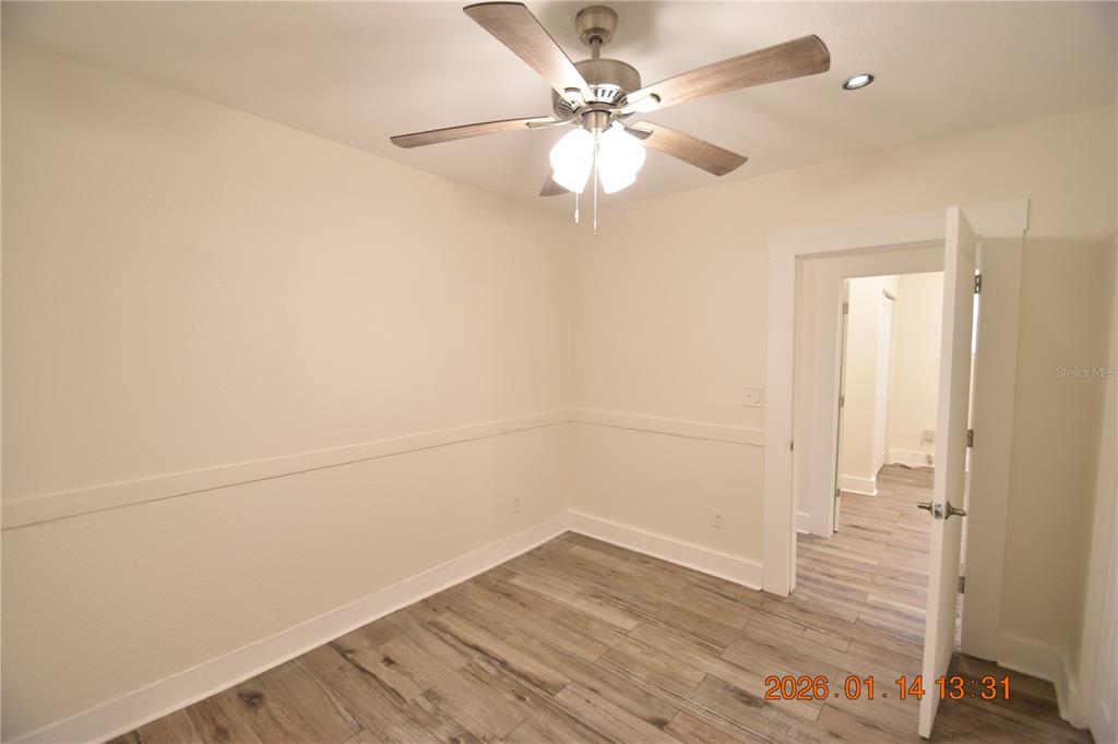 907 East Patterson Street Tampa, FL 33604 - Photo 18 of 35 wooden floor in an empty room with a chandelier fan