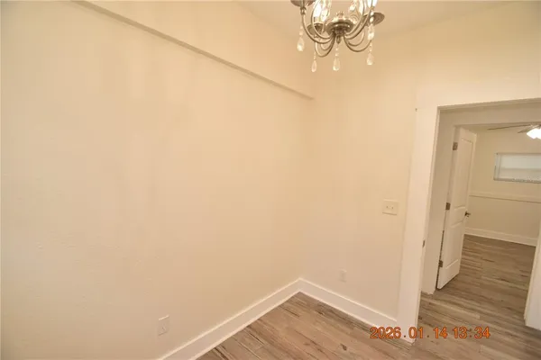 a view of a room with wooden floor