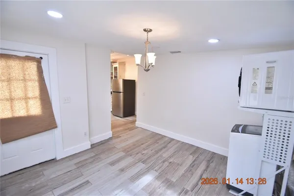 a view of a room with wooden floor staircase and a living room