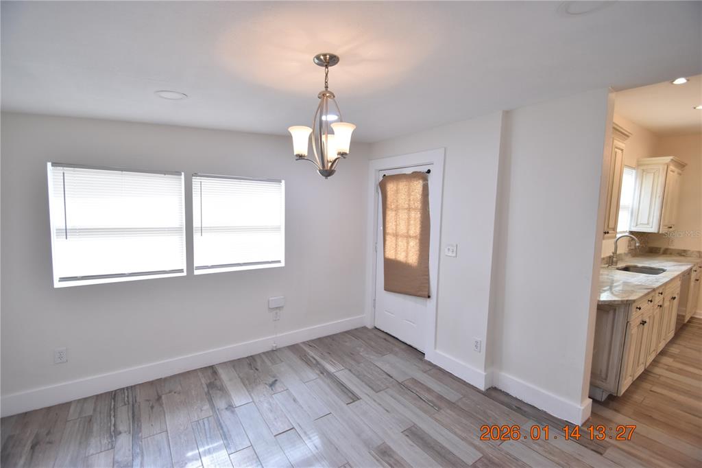 907 East Patterson Street Tampa, FL 33604 - Photo 9 of 35 a view of a room with wooden floors cabinets and a window