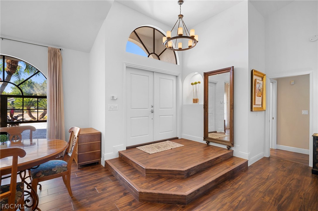 11772 Mahogany Run Fort Myers, FL 33913 - Photo 6 of 50 a room with chandelier fan and wooden floor