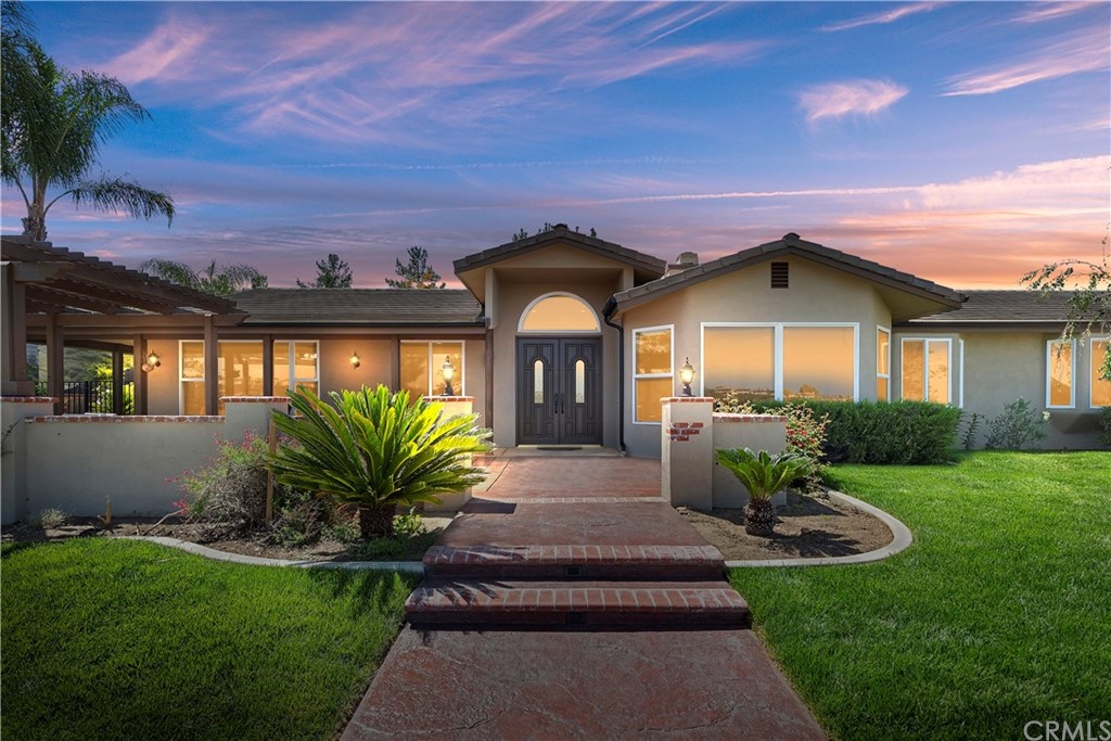 a front view of a house with a garden