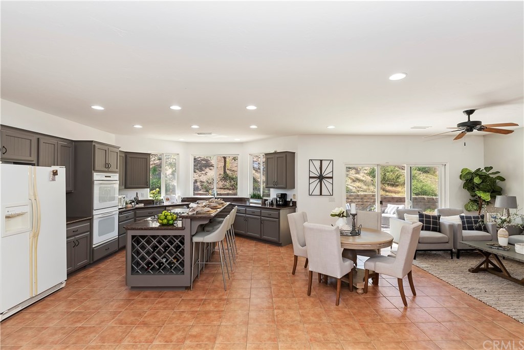 33425 Monte Verde Temecula, CA 92592 - Photo 19 of 68 a living room with furniture and a dining table with kitchen view
