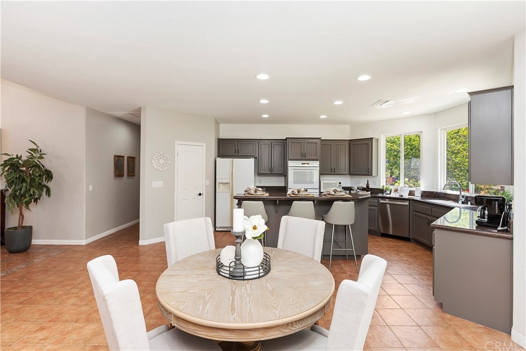 33425 Monte Verde Temecula, CA 92592 - Photo 28 of 68 a large kitchen with a table and chairs