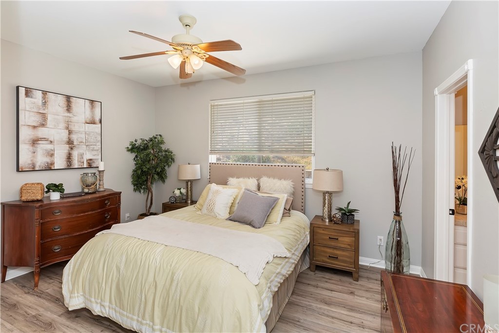 33425 Monte Verde Temecula, CA 92592 - Photo 35 of 68 a bedroom with a large bed and a chandelier