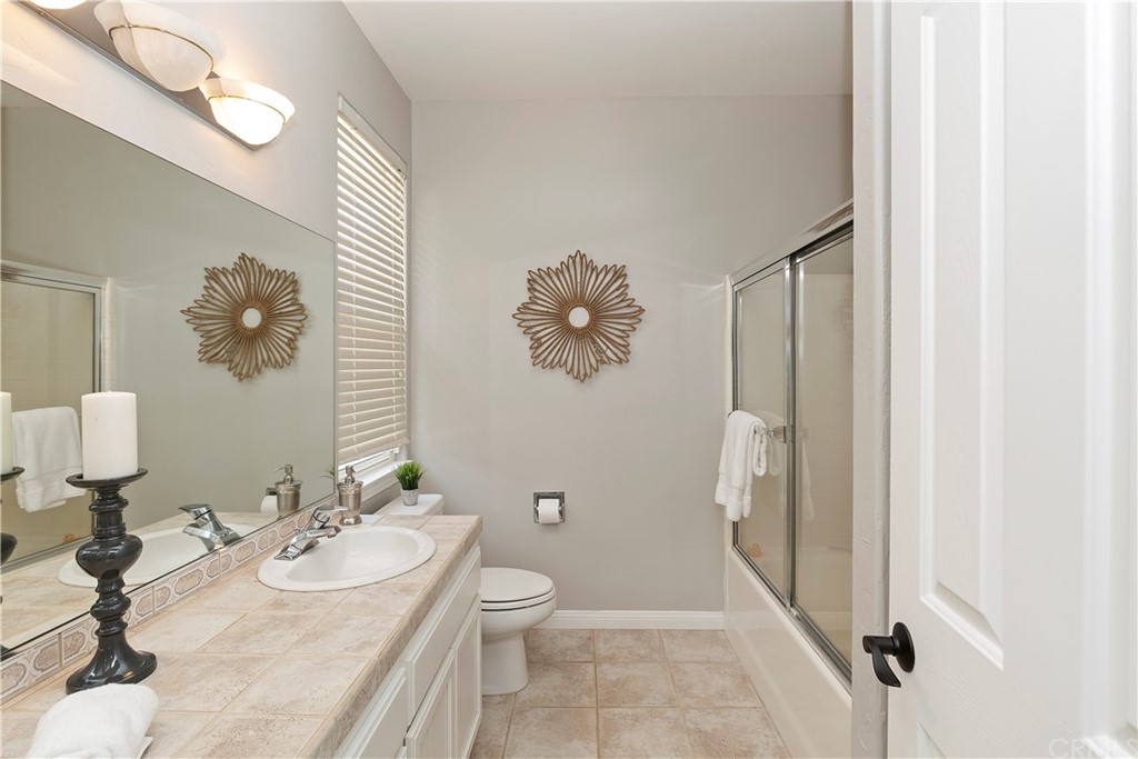 33425 Monte Verde Temecula, CA 92592 - Photo 36 of 68 a bathroom with a sink a toilet and shower a mirror