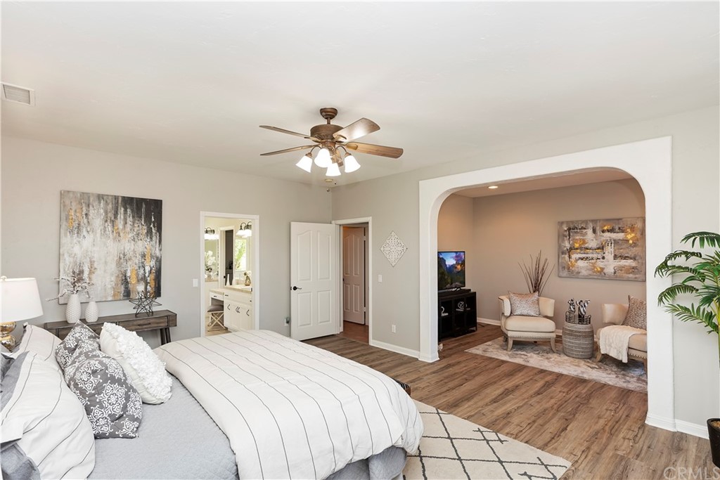 33425 Monte Verde Temecula, CA 92592 - Photo 40 of 68 a bedroom with a large bed and a chandelier