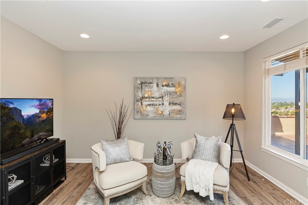 33425 Monte Verde Temecula, CA 92592 - Photo 41 of 68 a living room with furniture a flat screen tv and a window