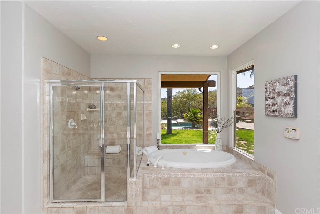 33425 Monte Verde Temecula, CA 92592 - Photo 44 of 68 a bathroom with a shower and a bathtub