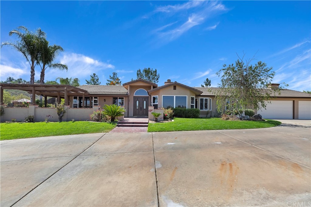 33425 Monte Verde Temecula, CA 92592 - Photo 7 of 68 a view of a white house with a yard and potted plants