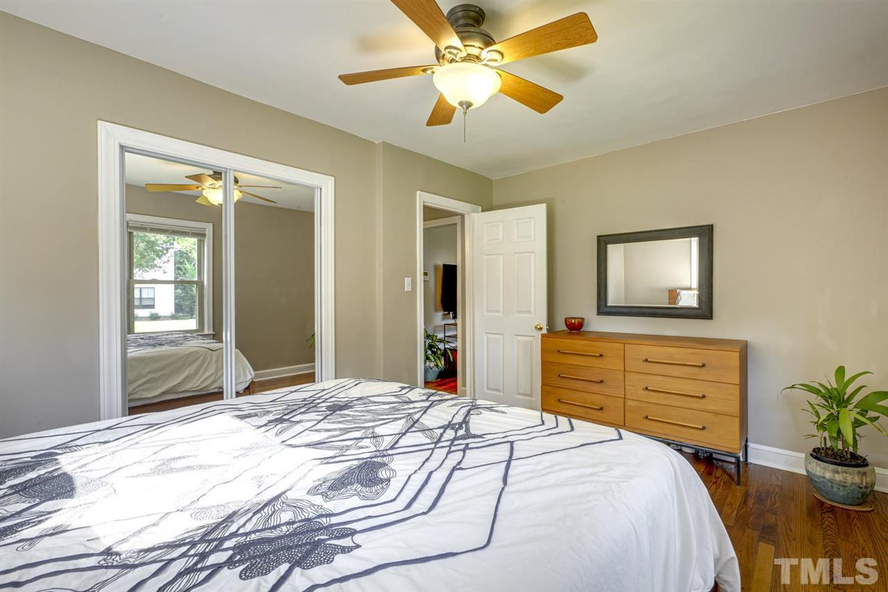 710 Penn Road Raleigh, NC 27604 - Photo 22 of 30 a bedroom with a bed and a chandelier