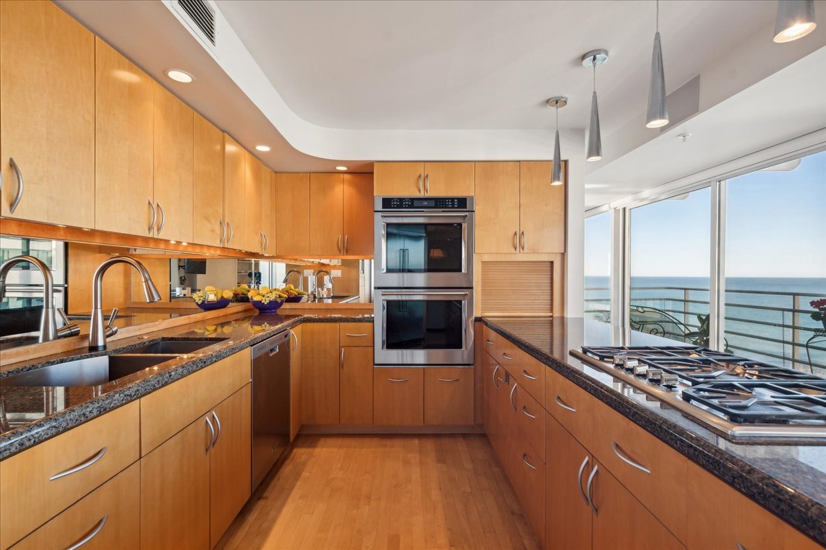 1618 Sheridan Road, Unit PH Wilmette, IL 60091 - Photo 15 of 49 a kitchen with stainless steel appliances granite countertop a stove and a sink