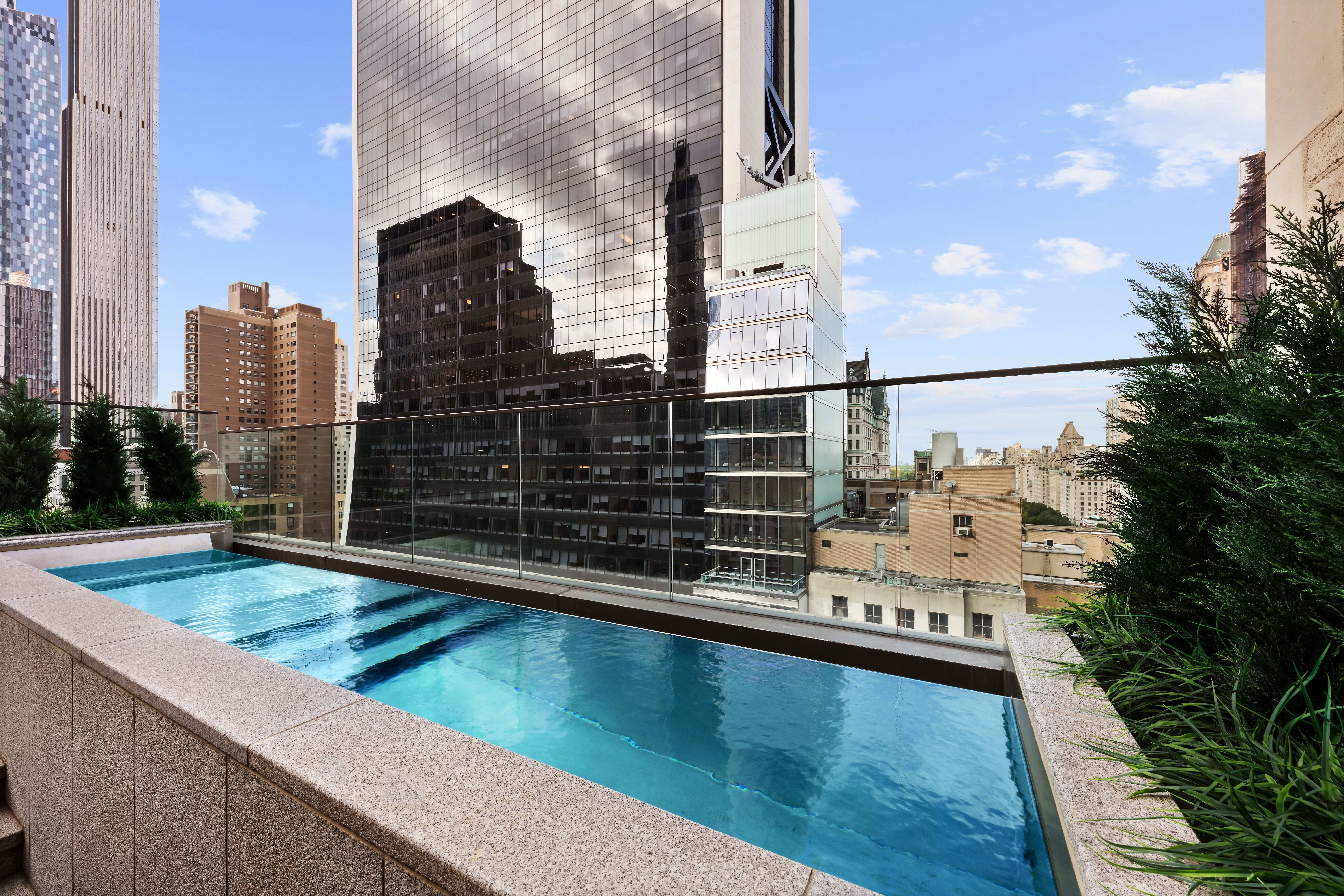 730 5th Avenue, Unit 18B Manhattan, NY 10019 - Photo 3 of 10 a view of swimming pool with outdoor seating and city view