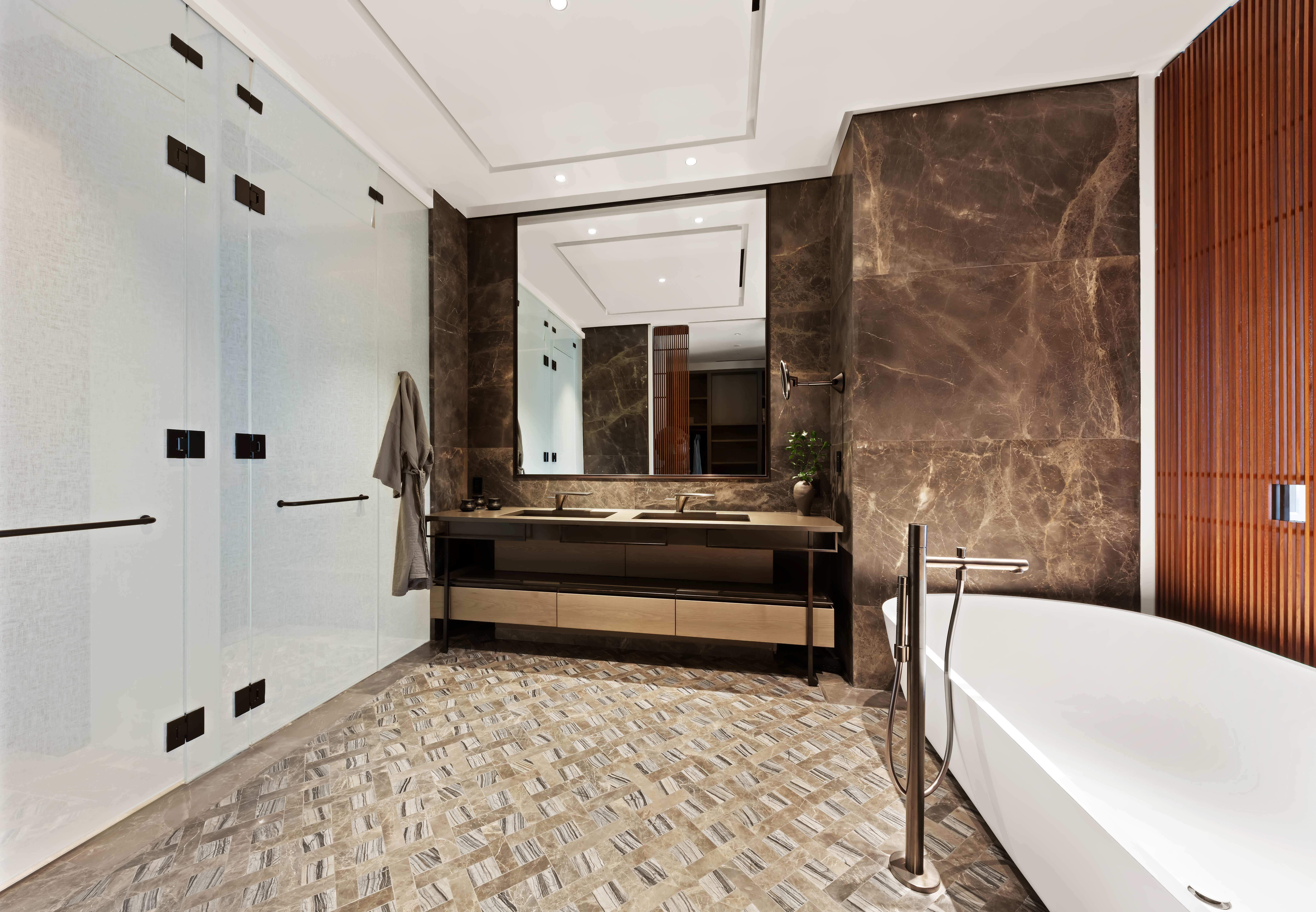 730 5th Avenue, Unit 18B Manhattan, NY 10019 - Photo 7 of 10 a bathroom with a tub sink shower and mirror