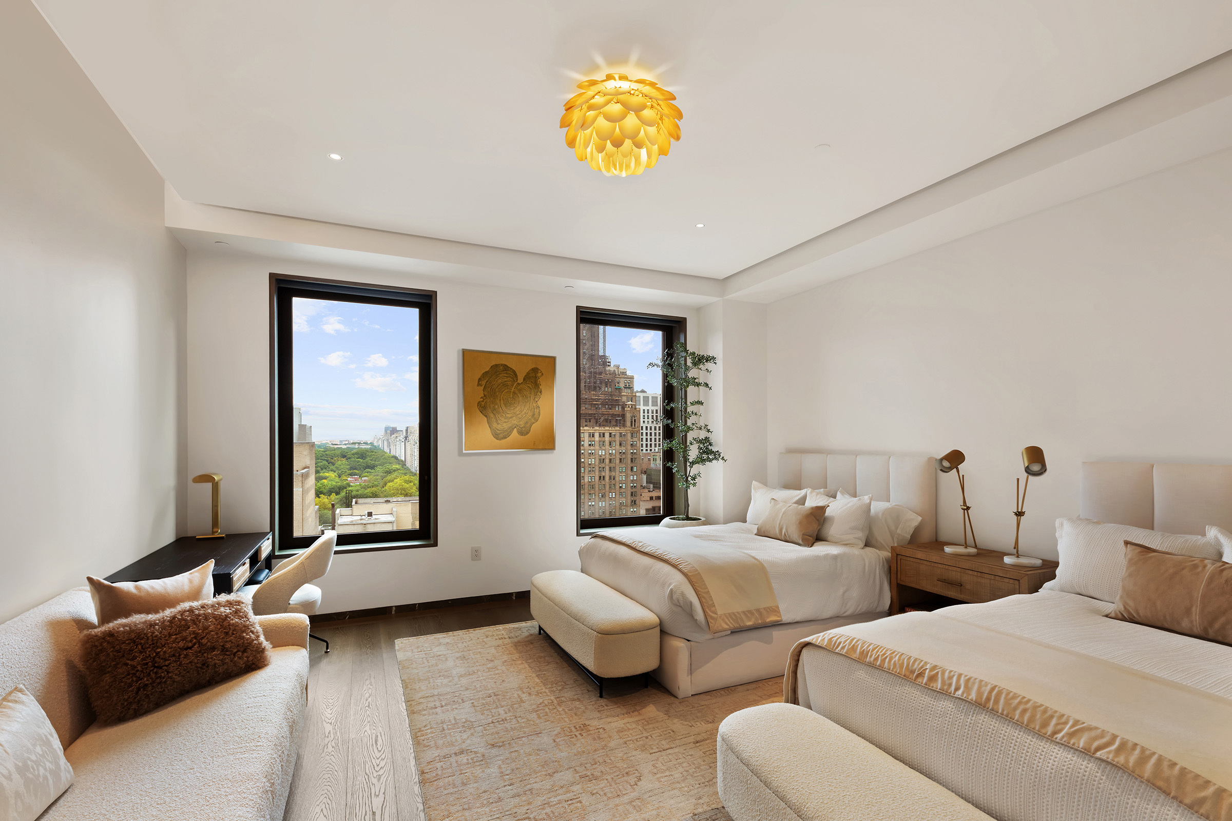 730 5th Avenue, Unit 18B Manhattan, NY 10019 - Photo 8 of 10 a bedroom with two beds and a couch