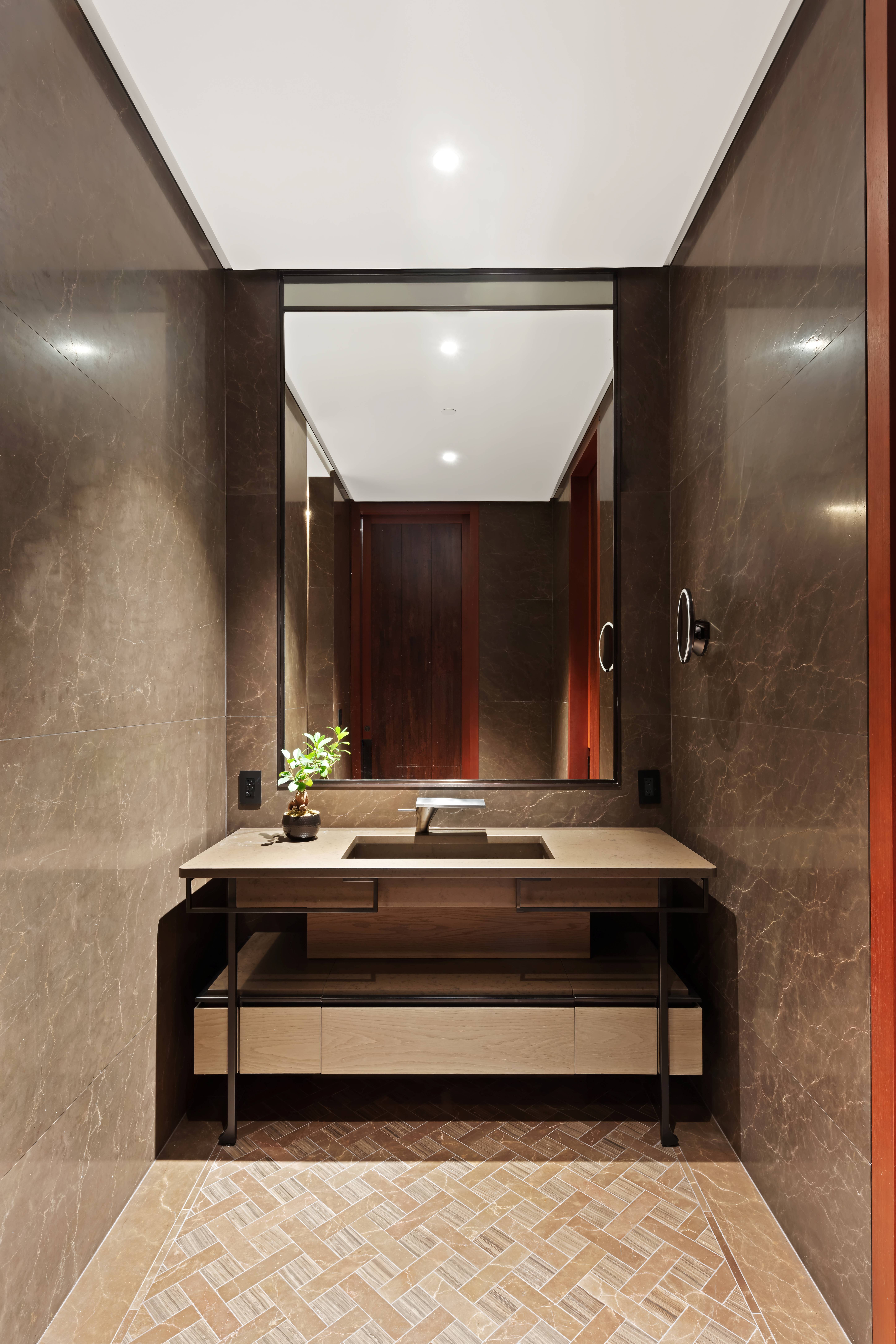 730 5th Avenue, Unit 18B Manhattan, NY 10019 - Photo 9 of 10 a bathroom with a sink and a mirror