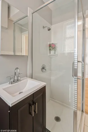 a bathroom with a sink toilet and shower