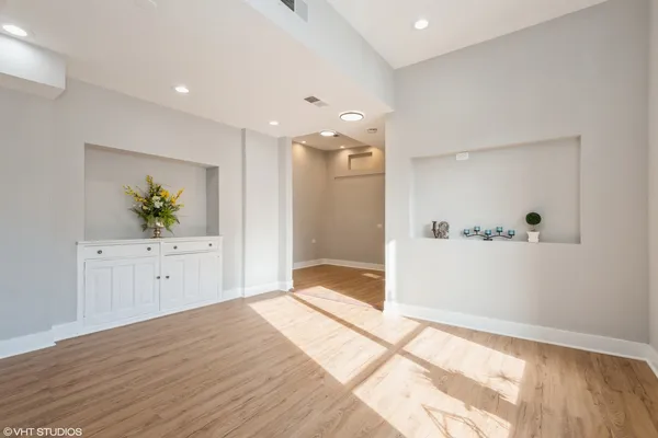 a kitchen with stainless steel appliances granite countertop a refrigerator stove a sink and dishwasher with wooden floor