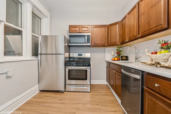 a kitchen with stainless steel appliances a refrigerator sink and microwave