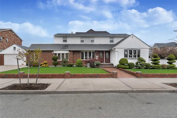 a front view of house with yard and green space