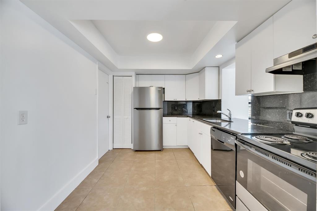 180 Southwest 78th Avenue Margate, FL 33068 - Photo 13 of 40 a kitchen with a refrigerator and a stove top oven