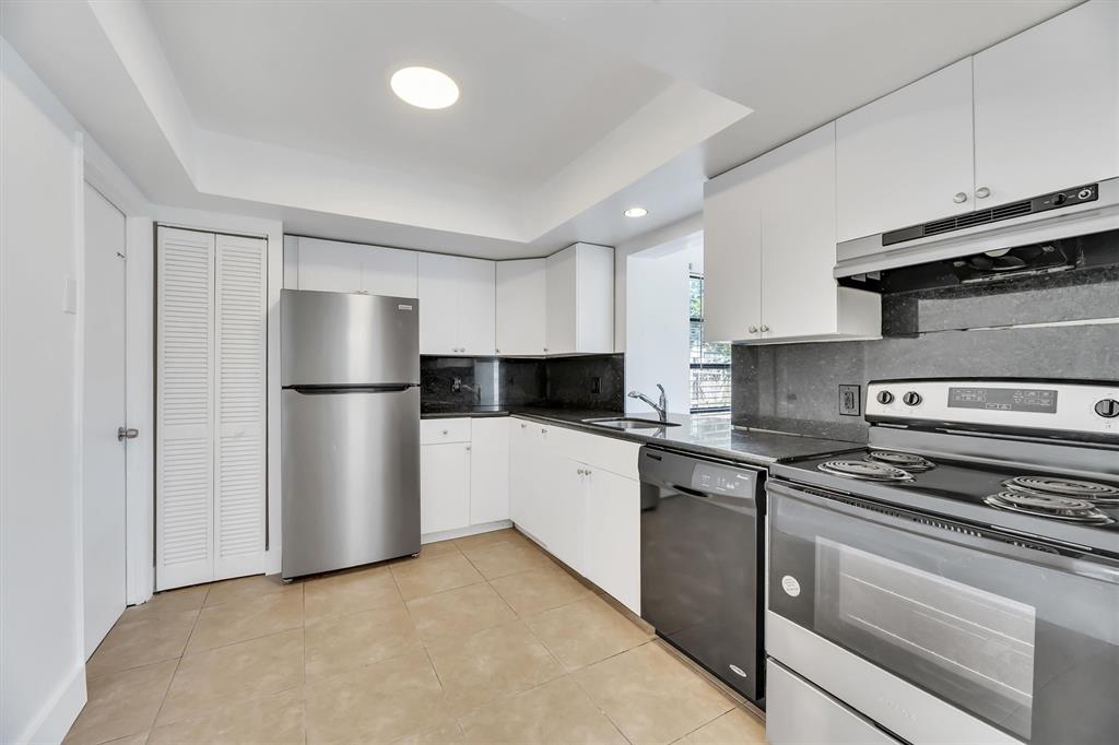 180 Southwest 78th Avenue Margate, FL 33068 - Photo 14 of 40 a kitchen with a refrigerator and a stove top oven