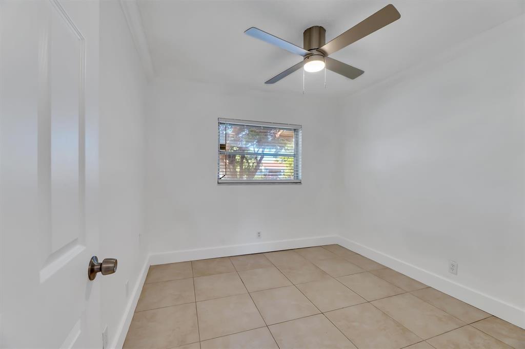 180 Southwest 78th Avenue Margate, FL 33068 - Photo 33 of 40 an empty room with a window and a fan