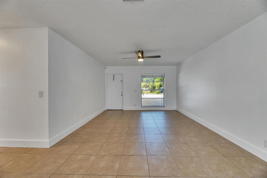 180 Southwest 78th Avenue Margate, FL 33068 - Photo 6 of 40 an empty room with windows