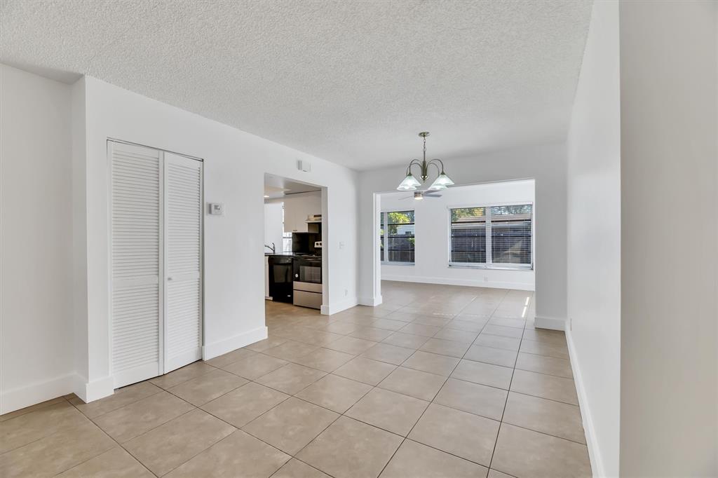 180 Southwest 78th Avenue Margate, FL 33068 - Photo 8 of 40 an empty room with kitchen view and a window