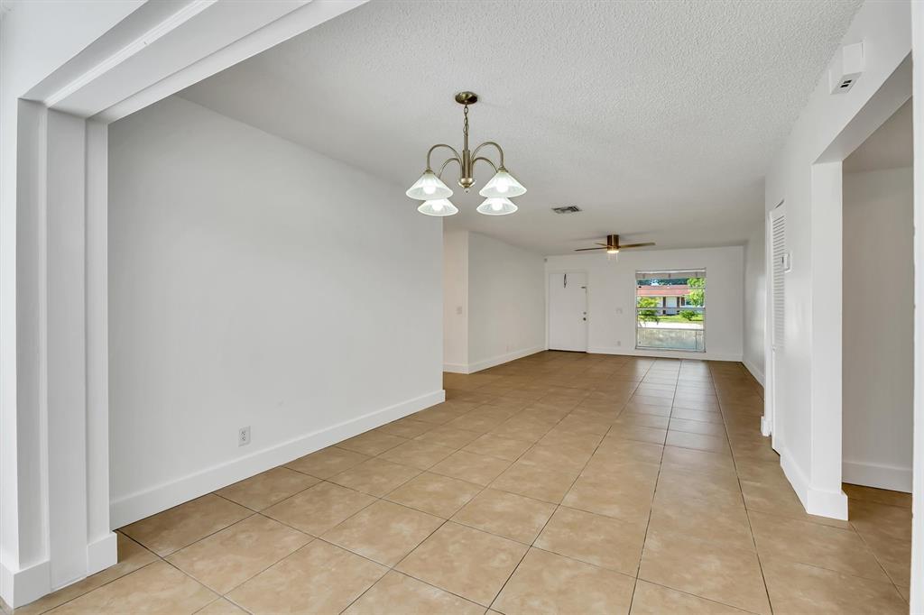 180 Southwest 78th Avenue Margate, FL 33068 - Photo 10 of 40 a view of a room with a window and a chandelier fan