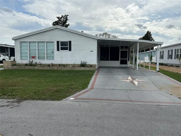 a front view of a house with a garden and porch