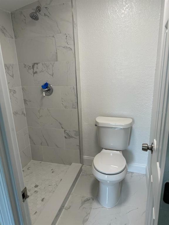 39638 Sunvalley Drive Zephyrhills, FL 33542 - Photo 11 of 14 a white toilet sitting next to a bath tub