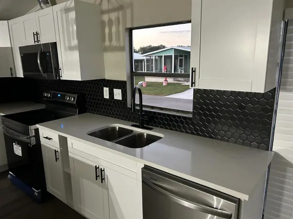 a kitchen with a sink and a stove