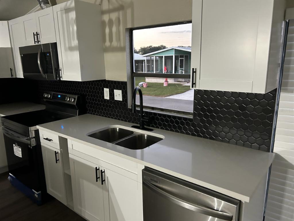 39638 Sunvalley Drive Zephyrhills, FL 33542 - Photo 3 of 14 a kitchen with a sink and a stove