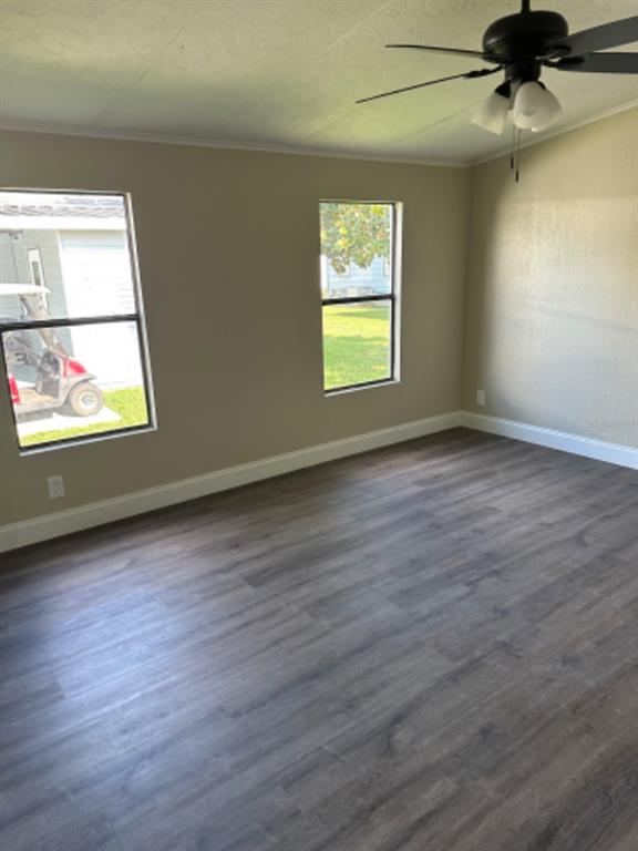 39638 Sunvalley Drive Zephyrhills, FL 33542 - Photo 8 of 14 an empty room with wooden floor fan and windows