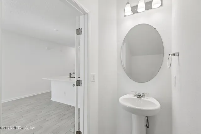 a bathroom with a sink a mirror and vanity