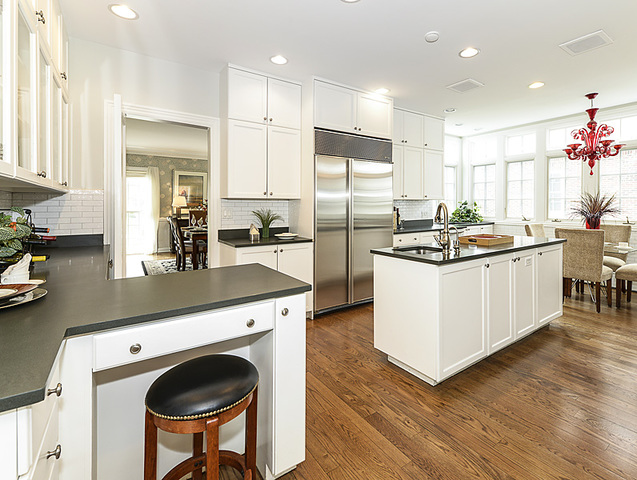 227 Raleigh Road Kenilworth, IL 60043 - Photo 17 of 40 a kitchen with kitchen island a sink a stove and a refrigerator